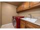 Laundry room with washer, dryer, and utility sink at 2105 Lookout Point Cir, Las Vegas, NV 89117