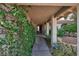 Covered walkway with lush greenery leading to the front door at 8941 Borla Dr, Las Vegas, NV 89117