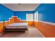 Bedroom with double bed and blue and orange walls at 8941 Borla Dr, Las Vegas, NV 89117