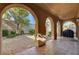 Covered patio with arched entryway and access to backyard at 12116 Montura Rosa Pl, Las Vegas, NV 89138