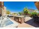 Outdoor kitchen and patio area with built-in grill, sink, and seating at 6391 Tempting Choice Ave, Las Vegas, NV 89131