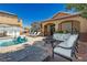 Inviting backyard with pool, patio furniture, and fire pit at 6391 Tempting Choice Ave, Las Vegas, NV 89131