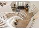 View of a curved staircase, wood floors, and living room below at 6391 Tempting Choice Ave, Las Vegas, NV 89131