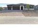 Two-story house with a three-car garage and landscaped yard at 4701 E Sandalwood Dr, Pahrump, NV 89061