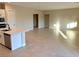 Open concept living room and kitchen with tile floors at 4701 E Sandalwood Dr, Pahrump, NV 89061