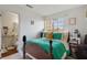 Bedroom with teal bedding, wood furniture and en-suite bathroom at 3482 Lorilou Ln # B, Las Vegas, NV 89121