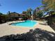 Community pool with patio and lounge chairs at 3482 Lorilou Ln # B, Las Vegas, NV 89121