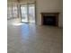 Living room with tile floors, fireplace, and sliding door to patio at 641 Bourbon St # I2, Pahrump, NV 89048