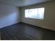 Spacious bedroom with hardwood floors and large window at 3364 Royce Ct, Las Vegas, NV 89121