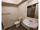 Bathroom with pedestal sink, toilet and a mirrored medicine cabinet at 3364 Royce Ct, Las Vegas, NV 89121