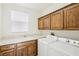 Laundry room with washer, dryer, cabinets, and sink at 11783 Weybrook Park Dr, Las Vegas, NV 89141