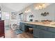 Elegant bathroom with double sinks, a soaking tub, and wood-look floors at 7400 Amigo St, Las Vegas, NV 89123