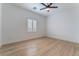 Bright bedroom with hardwood floors and ceiling fan at 6004 Chessington Ave, Las Vegas, NV 89131