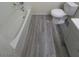 Bathroom with a bathtub and grey vinyl floor at 3805 Twig Ln, Las Vegas, NV 89108