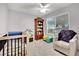 Bedroom with crib, armchair, and bookshelf at 4454 Honeydew Cir, Las Vegas, NV 89147