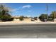 Street view of a classic single-story home with a large front yard and mature trees at 3416 Thom Blvd, Las Vegas, NV 89130