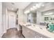 Elegant bathroom with double sinks, a large mirror, and a shower at 976 Via Panfilo Ave # 0, Henderson, NV 89011