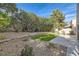 Landscaped backyard with artificial turf and a paved patio area at 23 Antero Dr, Henderson, NV 89074