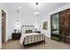 Serene bedroom with metal framed bed, private balcony, and modern art at 601 Overlook Rim Dr, Henderson, NV 89012