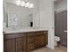 Double vanity bathroom with dark brown cabinets and a shower at 3038 Villanelle Ave, Las Vegas, NV 89044