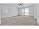 Main bedroom with ceiling fan and sliding glass doors to balcony at 246 Polaris Ridge Ave, Henderson, NV 89011