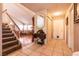 Entryway with staircase, tile floors, and views into living room at 1834 Escondido Ter, Henderson, NV 89074