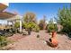 Relaxing backyard with covered patio, fire pit, and mature landscaping at 1834 Escondido Ter, Henderson, NV 89074