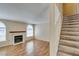 Living room featuring hardwood floors, fireplace, and staircase at 7732 Almeria Ave, Las Vegas, NV 89128