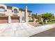 Two-story townhome with attached garage and landscaping at 7732 Almeria Ave, Las Vegas, NV 89128