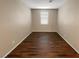 Bright bedroom with wood-look flooring and a window with blinds at 6217 Irene Porter St, North Las Vegas, NV 89031