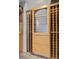 Close-up view of a built-in wine refrigerator and wooden wine racks at 11 Caminito Amore, Henderson, NV 89011