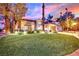 Beautiful home with landscaped lawn and dramatic sunset at 1841 Indian Bend Dr, Henderson, NV 89074