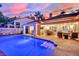 Inviting pool area with patio furniture and lighting at 1841 Indian Bend Dr, Henderson, NV 89074