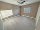 Bright bedroom featuring wood-look floors and ceiling fan at 3231 Mount Charleston Dr, Pahrump, NV 89048