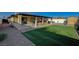 Backyard with covered patio, artificial turf, and brick pavers at 4729 Bennett Dr, Las Vegas, NV 89121