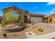 Single-story home with desert landscaping, two-car garage, and attractive facade at 977 Majestic Vw, Mesquite, NV 89034