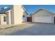 Rear view of house showing garage and gravel driveway at 1101 W Basin Ave, Pahrump, NV 89060