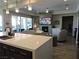 Open-concept kitchen with island, living area views, and fireplace at 270 Besame Ct, Las Vegas, NV 89138