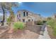 Two-story townhome with a walkway and lush landscaping at 3277 Dragon Fly St, North Las Vegas, NV 89032