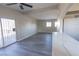 Spacious living area featuring gray vinyl plank flooring and a ceiling fan at 4485 S Nellis Blvd, Las Vegas, NV 89121