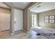 Entry hall with front door, den access, and light hardwood floors at 9538 Wild Valley Ave, Las Vegas, NV 89148