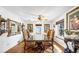 Elegant dining room featuring a large glass-top table, ornate chairs, and hardwood floors at 912 Santa Ynez Ave, Henderson, NV 89002