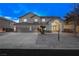 Two-story house with gray exterior, three-car garage, and landscaping at 9795 La Cienega St, Las Vegas, NV 89183