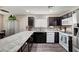 Modern kitchen with granite countertops, stainless steel appliances and dark cabinets at 3264 Sutters Fort St, North Las Vegas, NV 89032