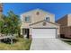 Two-story house with a white garage door and landscaping at 3264 Sutters Fort St, North Las Vegas, NV 89032