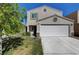 Two-story house with a white garage door and landscaping at 3264 Sutters Fort St, North Las Vegas, NV 89032