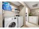 Laundry room with washer, dryer, and shelving for storage at 3264 Sutters Fort St, North Las Vegas, NV 89032