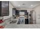 Modern kitchen with granite countertops and stainless steel appliances at 3264 Sutters Fort St, North Las Vegas, NV 89032