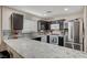 L-shaped kitchen boasts granite countertops and stainless steel appliances at 3264 Sutters Fort St, North Las Vegas, NV 89032