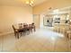 Dining area with tile flooring, wooden dining table and chairs, and view of kitchen at 1009 Winwood St, Las Vegas, NV 89108